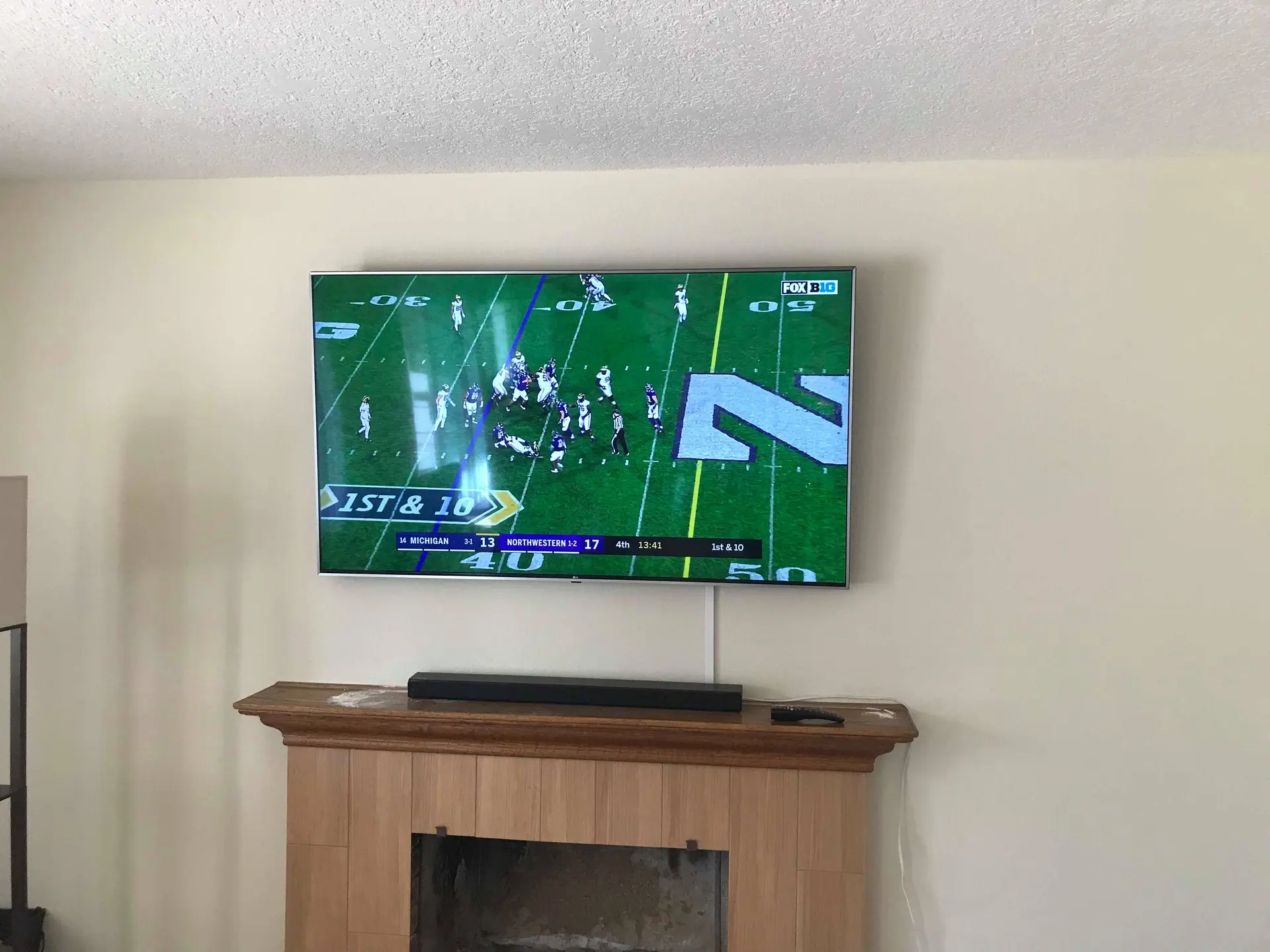 Samsung 75-inch TV mounted with tilting bracket for optimal viewing