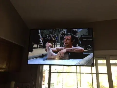 Clean TV mount with in-wall cord concealment in master bedroom